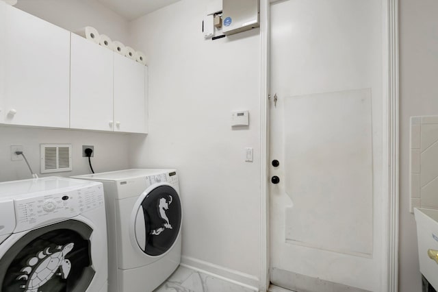 laundry room featuring cabinets and independent washer and dryer