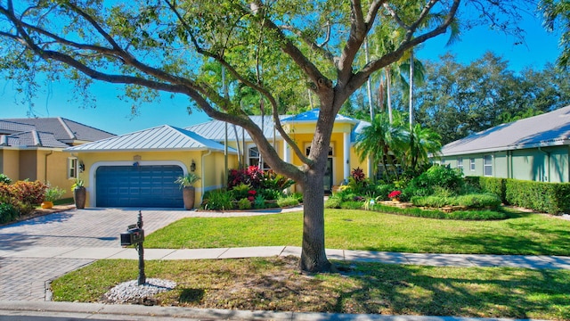 single story home featuring a front yard and a garage