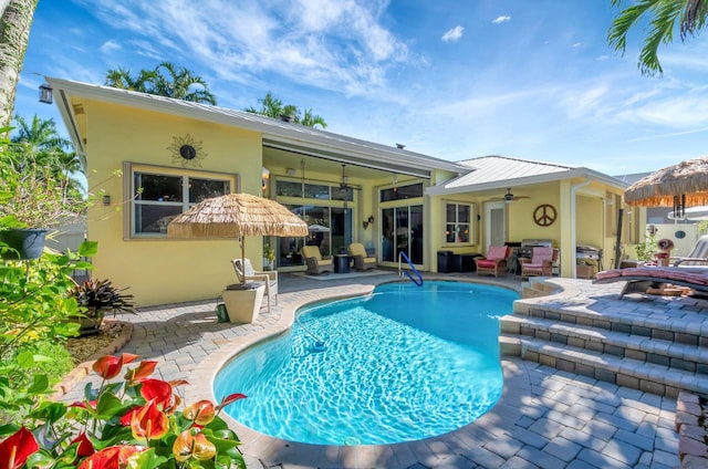 view of swimming pool with a patio area and ceiling fan