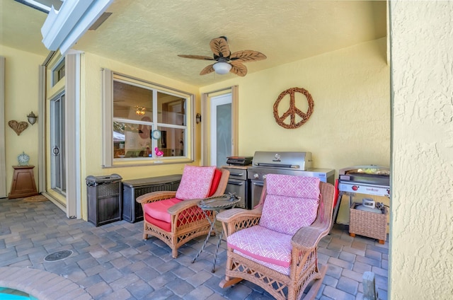 view of patio / terrace with area for grilling and ceiling fan