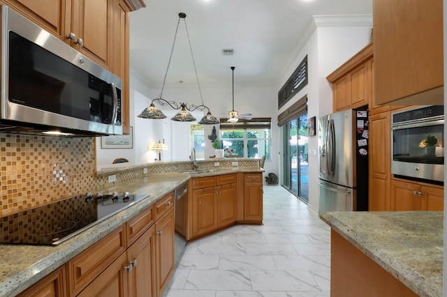 kitchen with backsplash, sink, hanging light fixtures, light stone counters, and stainless steel appliances