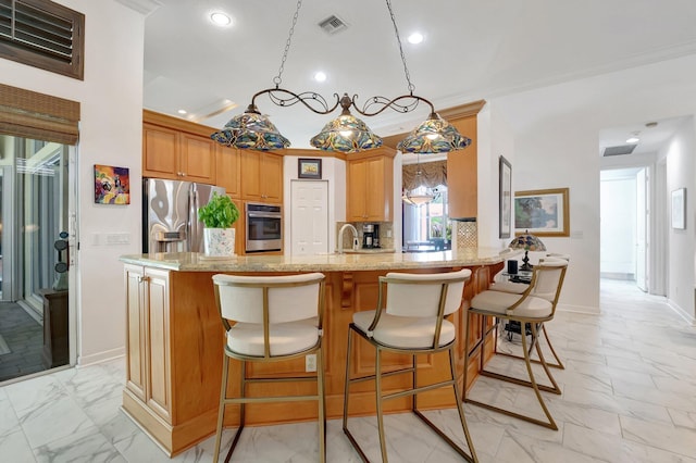 kitchen with kitchen peninsula, appliances with stainless steel finishes, tasteful backsplash, light stone counters, and ornamental molding