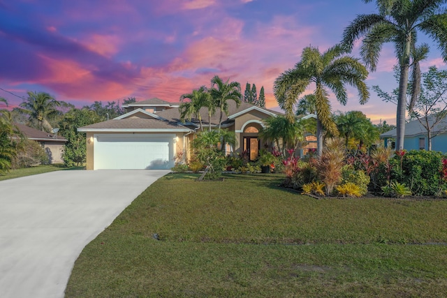 view of front of home with a lawn and a garage