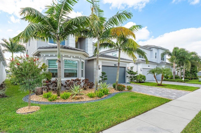 view of front of property featuring a garage and a front lawn