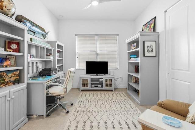 carpeted office space with ceiling fan