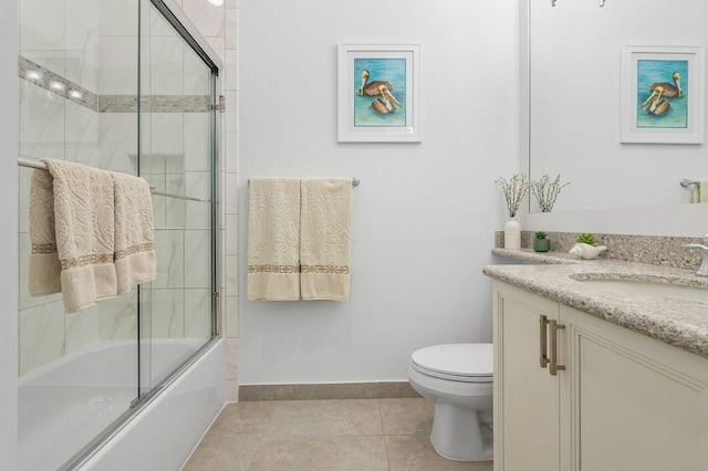 full bathroom featuring shower / bath combination with glass door, tile patterned floors, vanity, and toilet