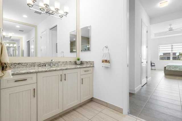 bathroom with ceiling fan, tile patterned flooring, and vanity