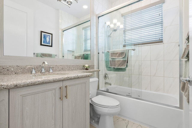 full bathroom with shower / bath combination with glass door, vanity, and toilet