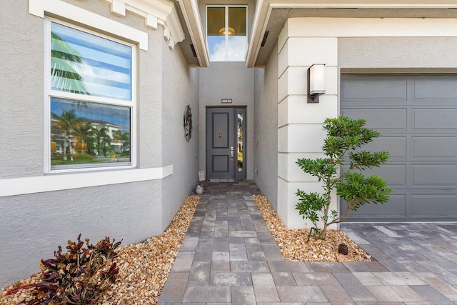 view of exterior entry featuring a garage