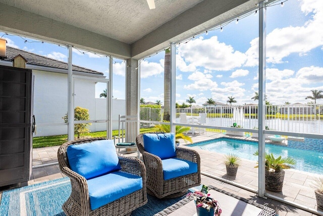 sunroom / solarium featuring a water view