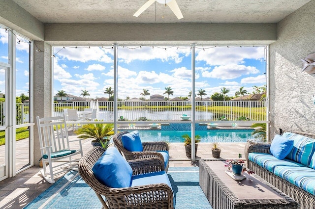 sunroom / solarium featuring a water view