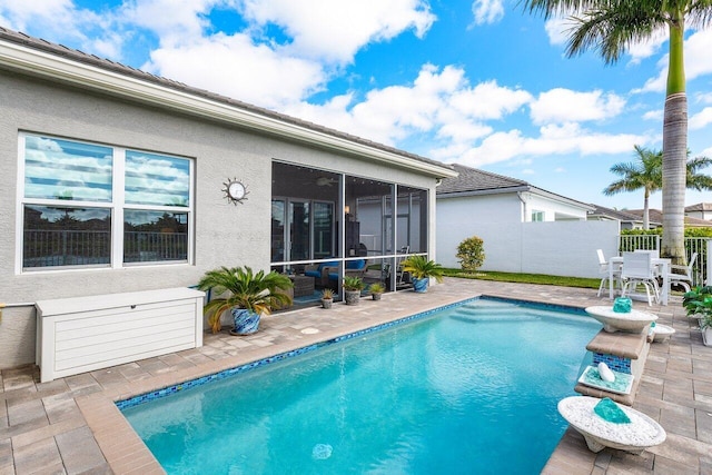 view of pool featuring a sunroom and a patio