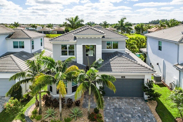 view of front of property with cooling unit and a garage