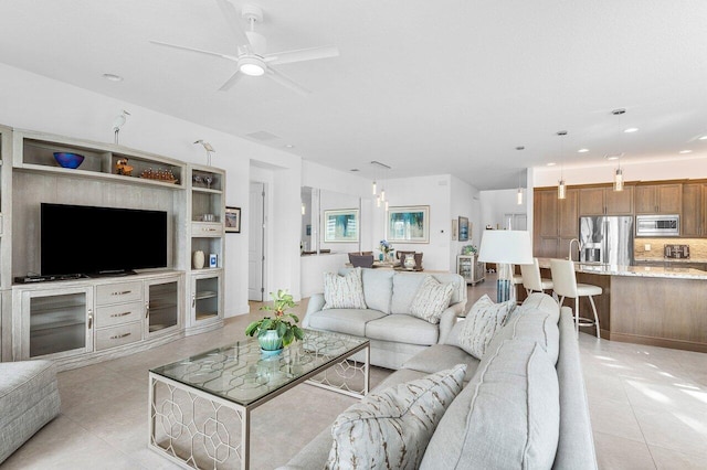 tiled living room with ceiling fan