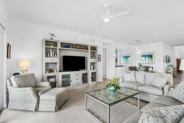 living room with ceiling fan and light tile patterned flooring