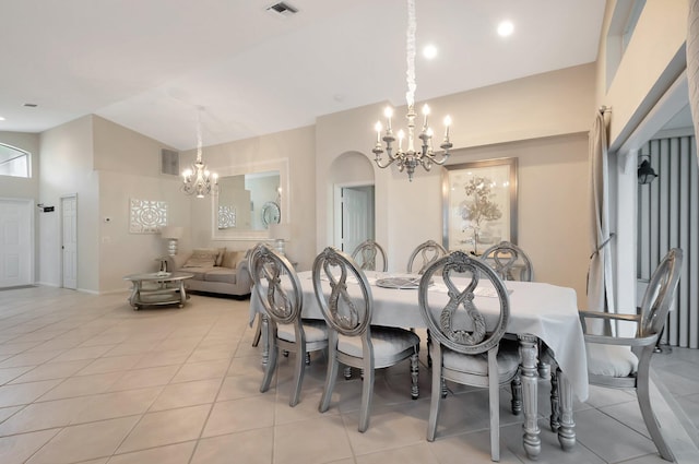 tiled dining room featuring a notable chandelier and a towering ceiling