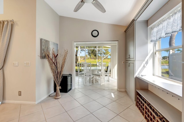 interior space featuring light tile patterned floors and vaulted ceiling