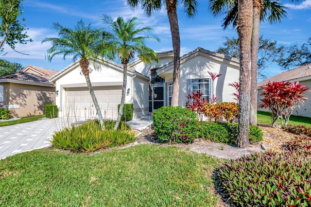 view of front of property with a front yard and a garage