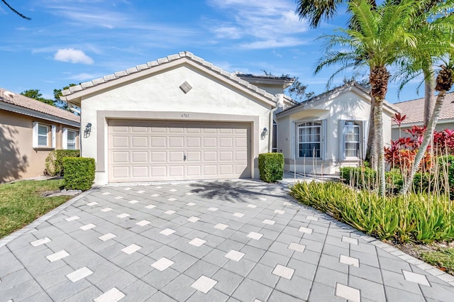 6761 Sun River Rd, Boynton Beach, FL 33437 - ranch-style house with concrete driveway, stucco siding, and an attached garage