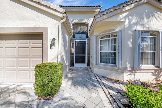 6761 Sun River Rd, Boynton Beach, FL 33437 - property entrance featuring stucco siding and a garage