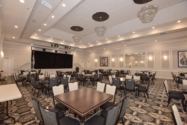 carpeted dining area with a tray ceiling