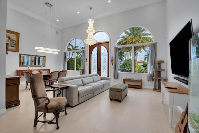 tiled living room featuring ornamental molding, a towering ceiling, french doors, and a notable chandelier