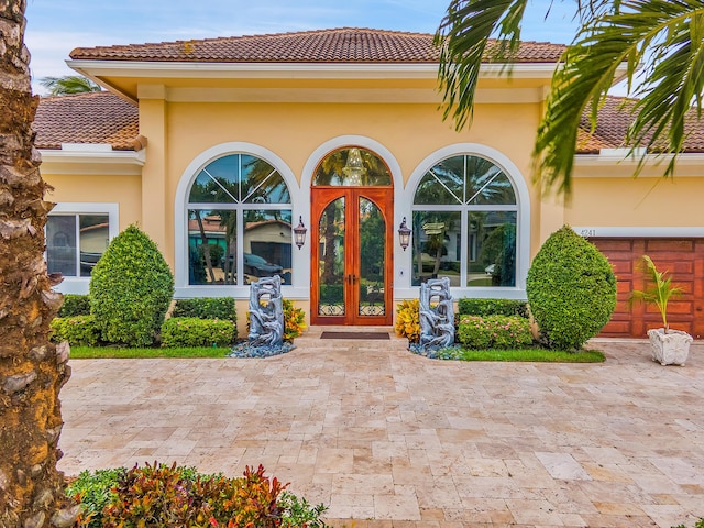 property entrance featuring french doors and a garage