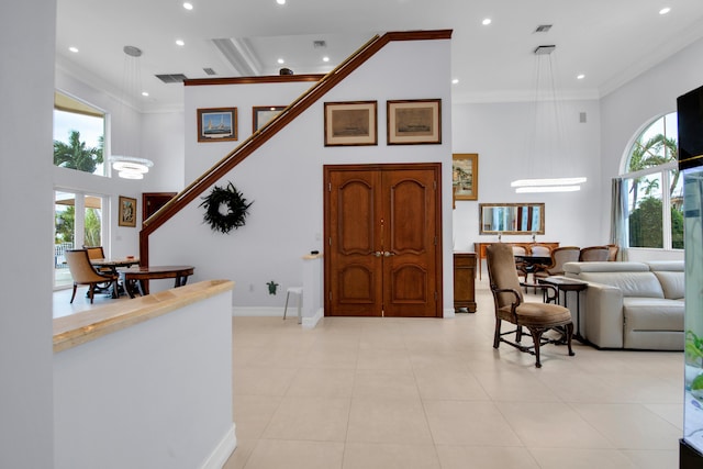 entryway with a healthy amount of sunlight and ornamental molding