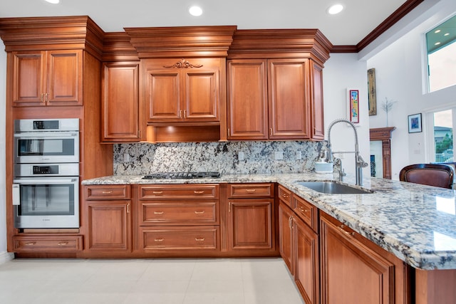 kitchen featuring sink, stainless steel double oven, tasteful backsplash, black gas cooktop, and light stone counters