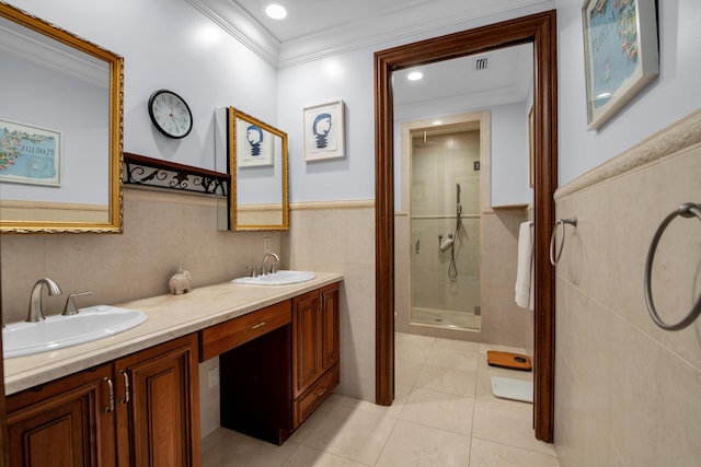 bathroom featuring vanity, tile patterned flooring, ornamental molding, tile walls, and an enclosed shower