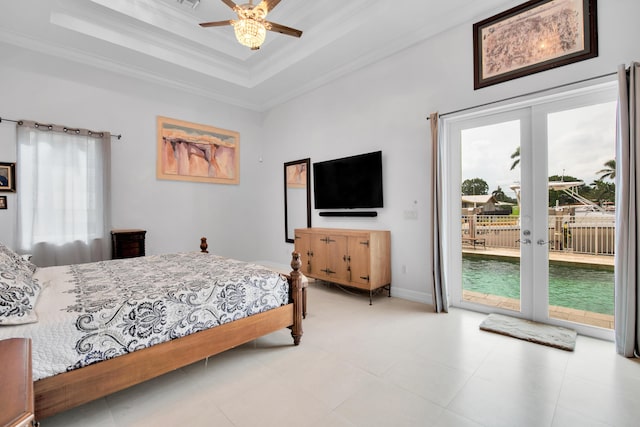 bedroom featuring access to exterior, ceiling fan, french doors, a raised ceiling, and crown molding