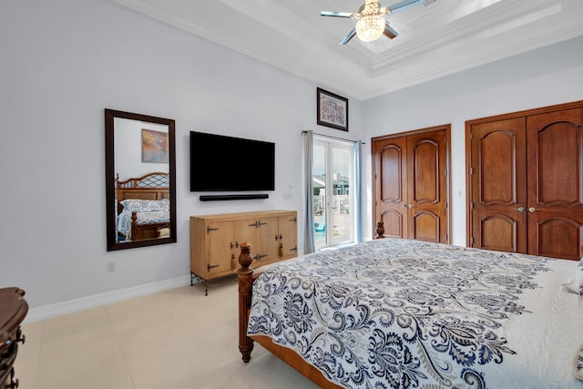 bedroom with a tray ceiling, ceiling fan, and ornamental molding