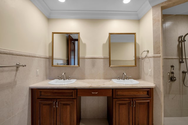 bathroom with vanity, tile walls, ornamental molding, and a shower with shower door