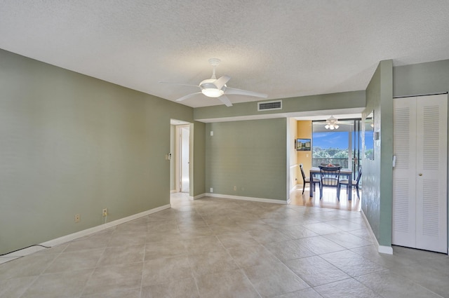 spare room featuring a textured ceiling and ceiling fan