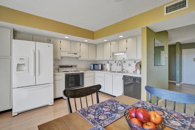 kitchen featuring tasteful backsplash, a textured ceiling, white appliances, sink, and light hardwood / wood-style flooring