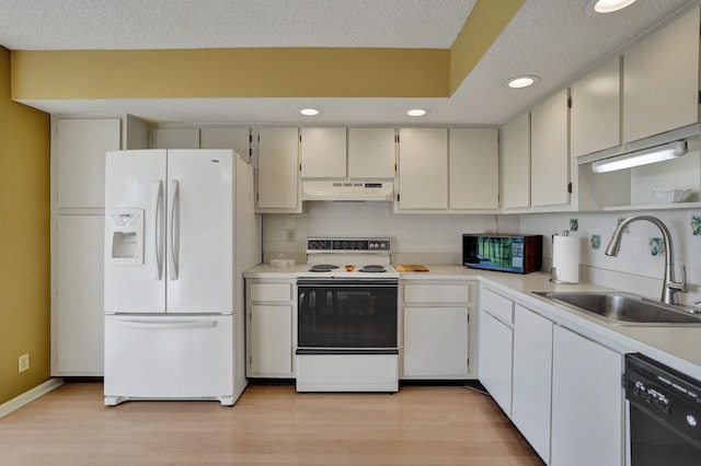 kitchen featuring white appliances, backsplash, sink, light hardwood / wood-style floors, and white cabinetry