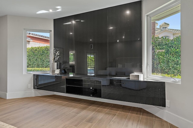 kitchen featuring a wealth of natural light and light hardwood / wood-style flooring