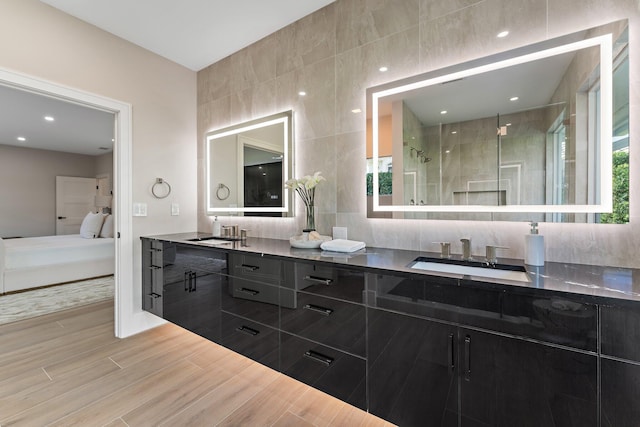 bathroom with vanity and a shower with door