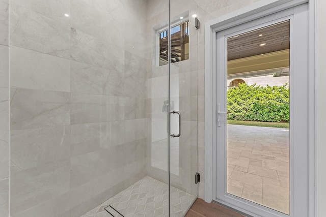 bathroom with a shower with door