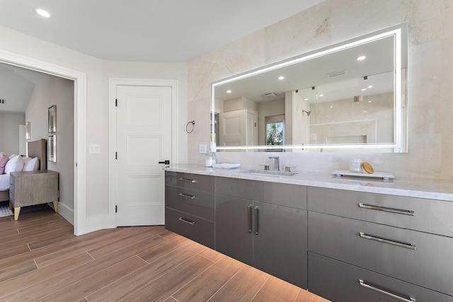 bathroom featuring vanity and backsplash