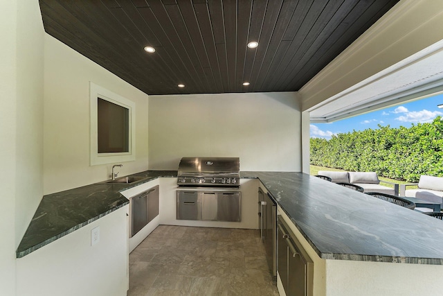 view of patio with exterior kitchen, sink, and a grill