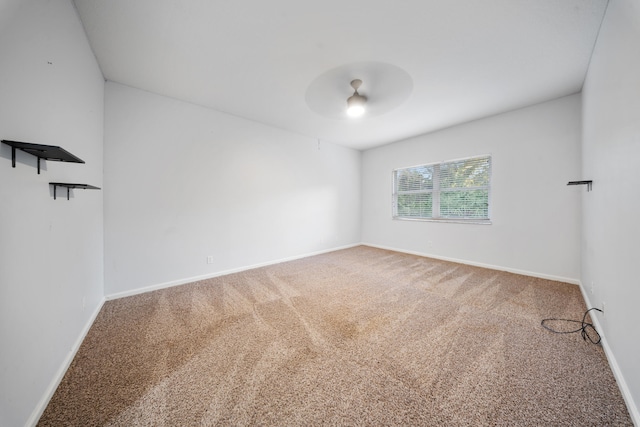 unfurnished room with carpet and ceiling fan