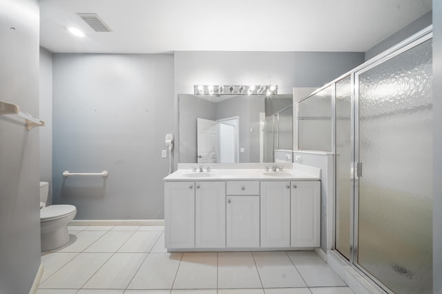 bathroom with tile patterned flooring, vanity, an enclosed shower, and toilet