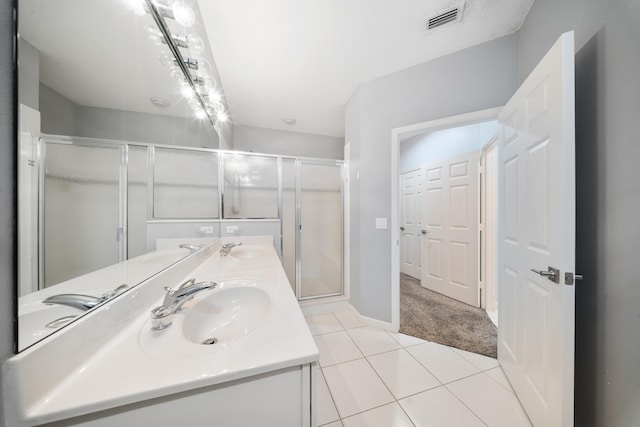 bathroom with vanity, tile patterned floors, and a shower with door