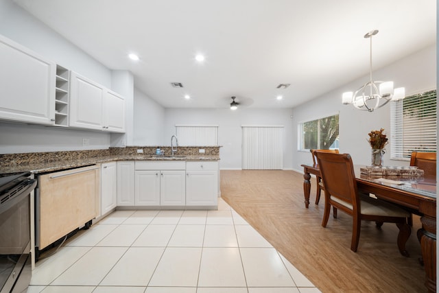 kitchen featuring stainless steel appliances, sink, a chandelier, white cabinetry, and light tile patterned flooring