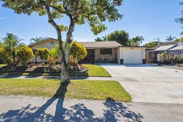 ranch-style home with a garage and a front lawn