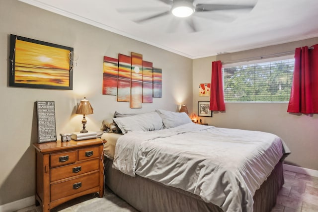 bedroom with ceiling fan and ornamental molding