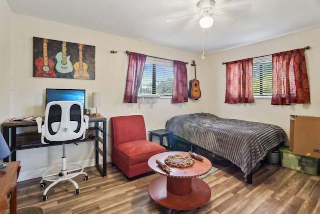 bedroom with ceiling fan and hardwood / wood-style flooring