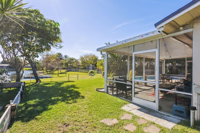 view of yard with a sunroom