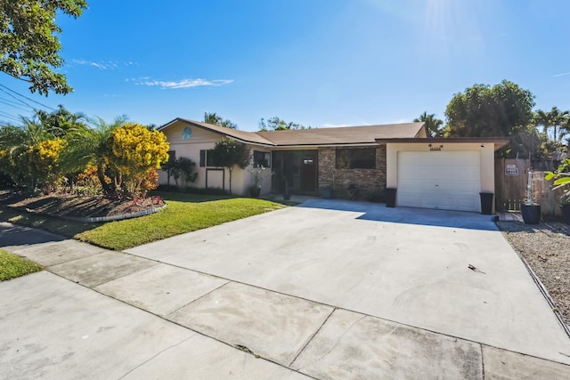 ranch-style home with a garage and a front yard